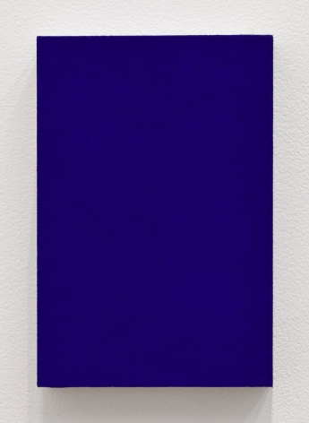 Blue rectangle painting hanging on white wall