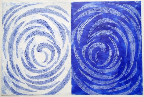 Right half has blue swirls on white background and left half has white swirls on blue background