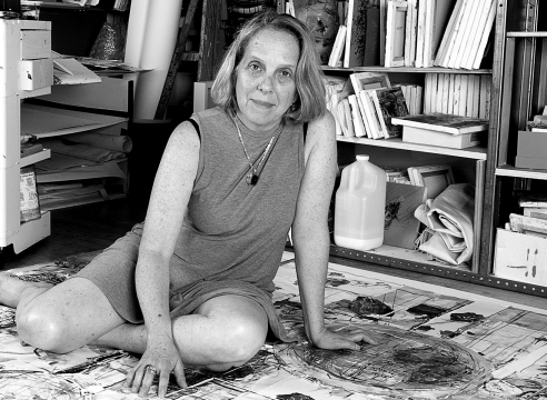 Black and white photo of Judy Glantzman in her studio